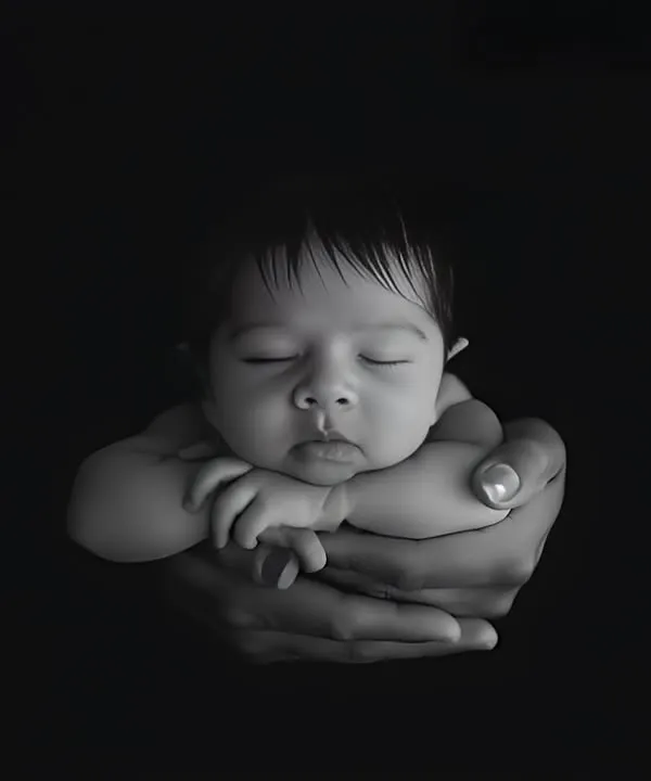 I believe every photograph should tell a story. This classic black and white portrait, with a newborn held safely in their parent's hands, is one of my all-time favorites because it captures the pure love and connection of those first few days.