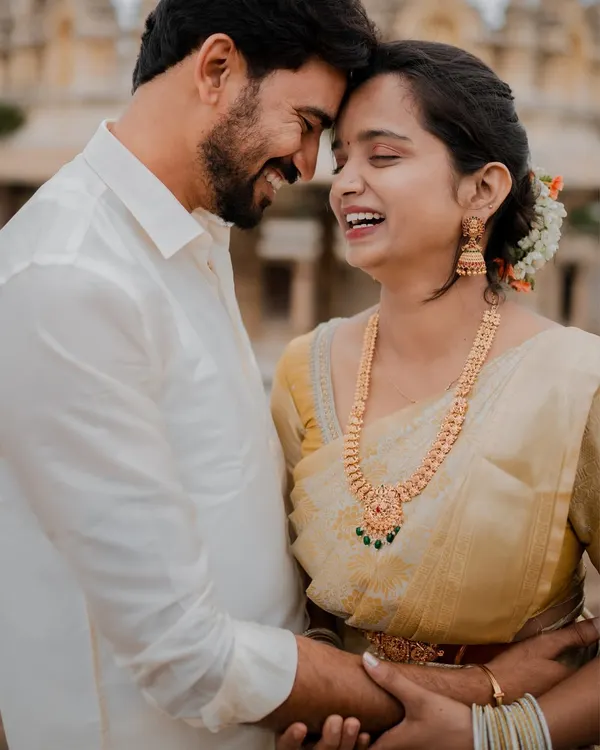 A moment of pure joy and laughter at the historic Melkote temple. The ancient stone pillars provide a stunning backdrop for this couple's modern love story.
