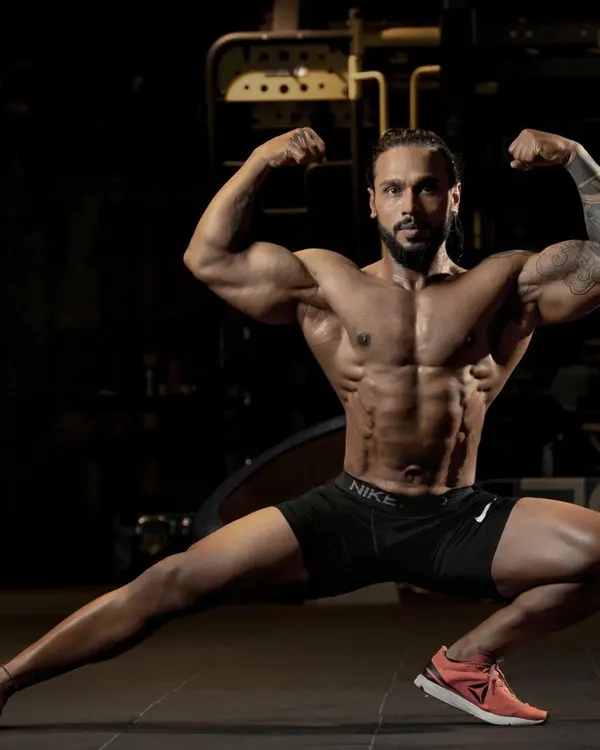 A classic bodybuilding pose demonstrating overall muscularity, from the biceps and chest to the quadriceps. Posing is an art, and I coach aspiring athletes on how to best display their hard-earned physique.