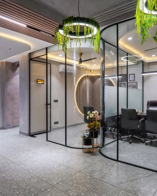 Welcome to the Shri Ram Construction office, a modern workspace I designed in Behra Enclave. The design features curved glass partitions, terrazzo tiles, and hanging planters to promote creativity and collaboration.