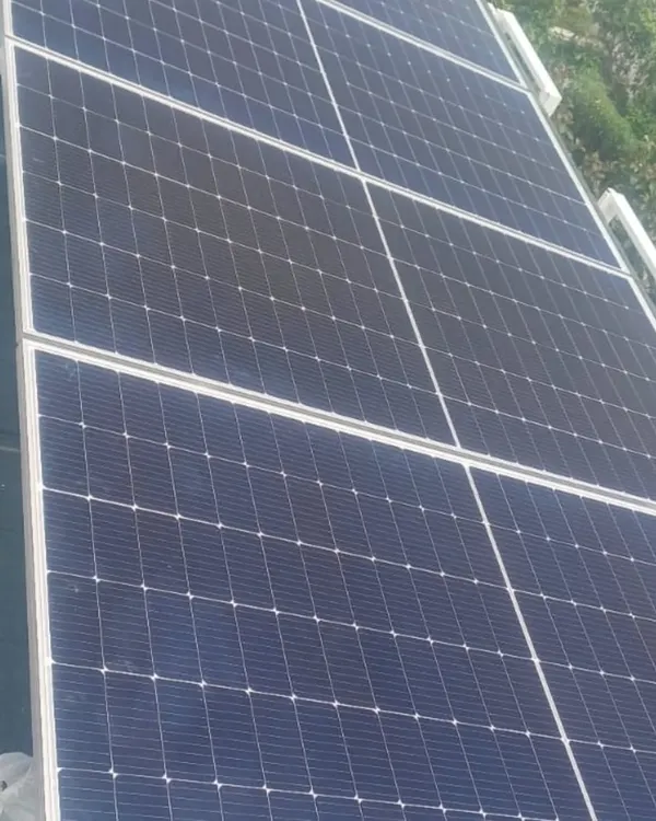 A clean installation of high-efficiency solar panels on a prefab home's roof. This system is designed to generate enough power for the home, reducing its carbon footprint and utility costs.