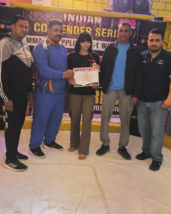 We don't just train, we build champions. Here is one of our athletes after winning a gold medal at the MMA Contender Series. The hard work in the gym pays off in the ring, and we are proud to coach fighters to victory.