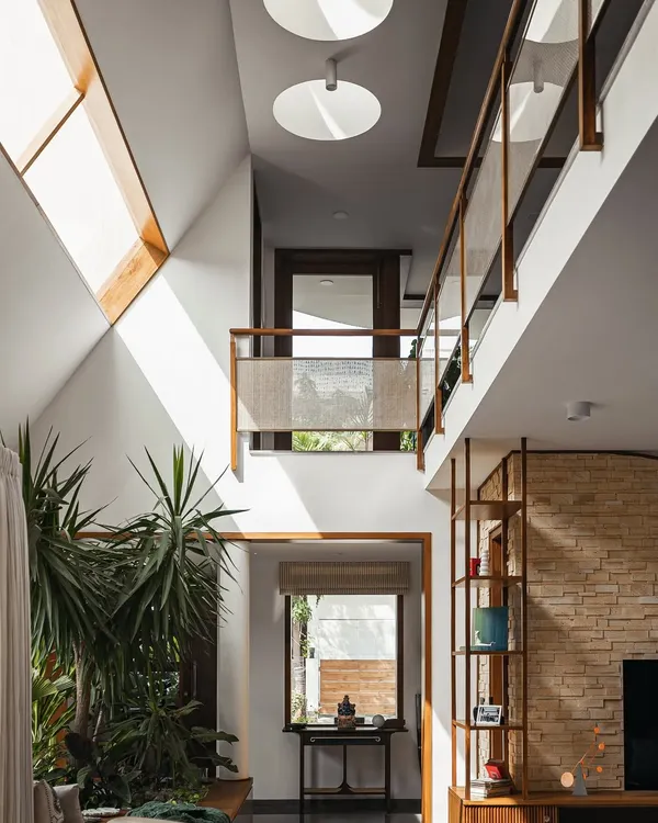 This double-height living space captures our core belief that light is the most important material in architecture. We used large skylights and an open bridge to fill the home with natural light, connecting the upper and lower floors while creating a sense of openness and tranquility.