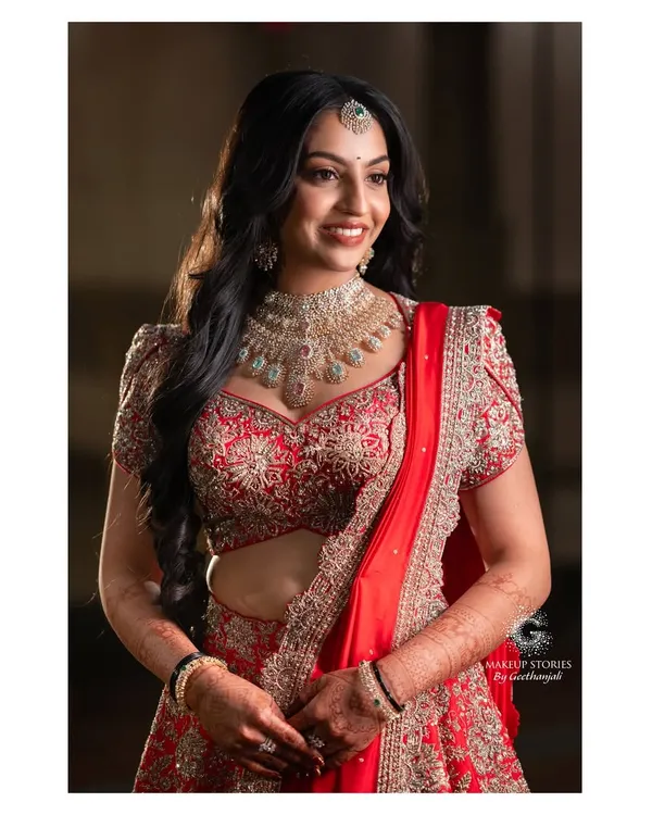 Likitha's radiant reception look in a stunning red lehenga. My course teaches you how to transition a bride's look from wedding to reception, often involving a bolder lip and more dramatic hair.