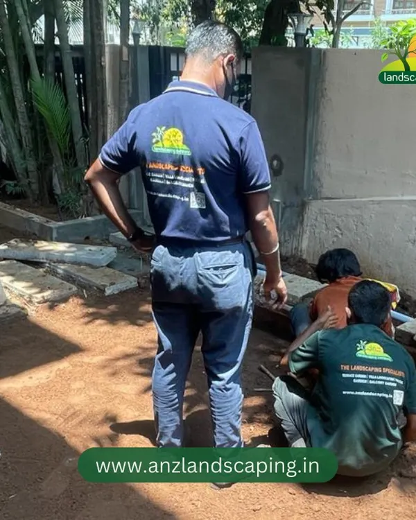 The first step in a great garden is proper preparation. Here, our team is leveling the ground and preparing the soil for lawn and pathway installation.
