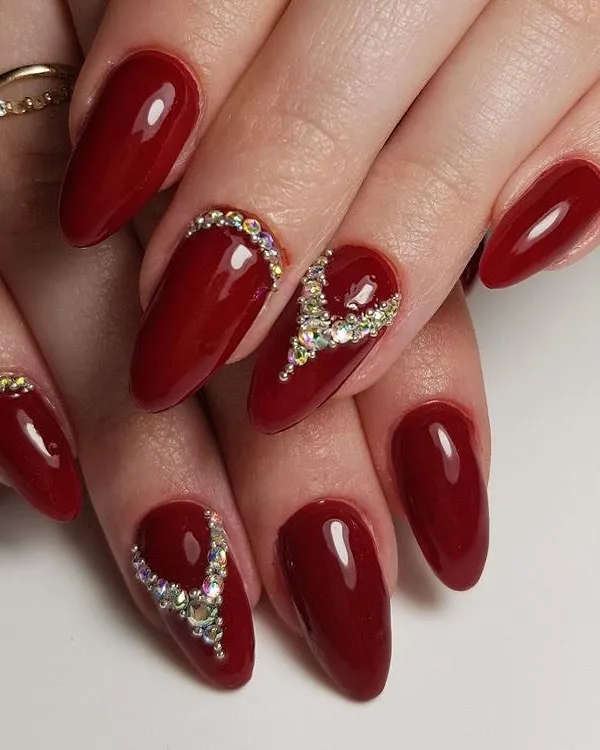 A classic and elegant bridal look featuring deep red gel polish on almond-shaped extensions. You will learn precise rhinestone placement techniques to create beautiful, durable patterns like these.