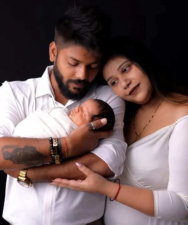 A quiet moment of connection between new parents and their baby. I use simple, classic lighting against a dark backdrop to draw all the focus to the family's loving embrace and peaceful expressions.