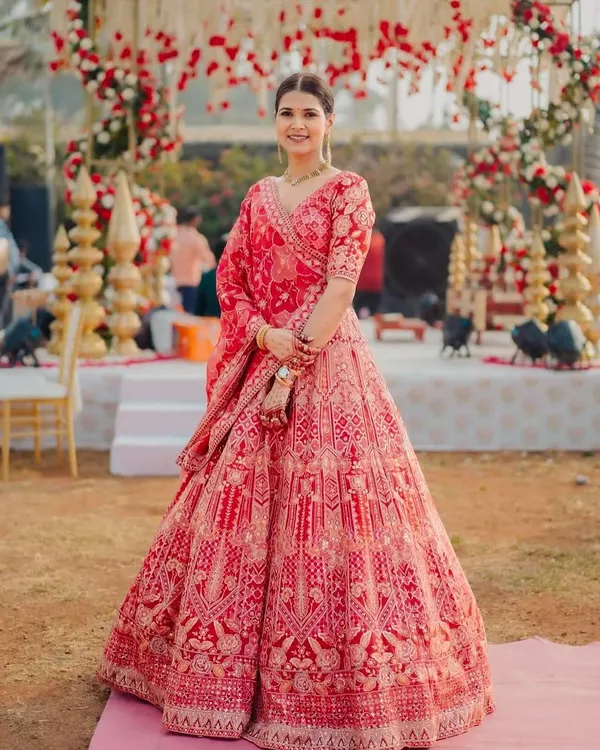 Aditi was a vision in her red bridal lehenga. We created a clean, classic look with a neat bun and makeup that highlighted her sharp features, ensuring she looked absolutely regal for her wedding ceremony. ❤️