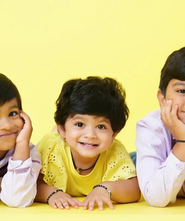 The magic of childhood friendship between siblings and cousins. This bright and happy studio portrait captures their beautiful smiles.