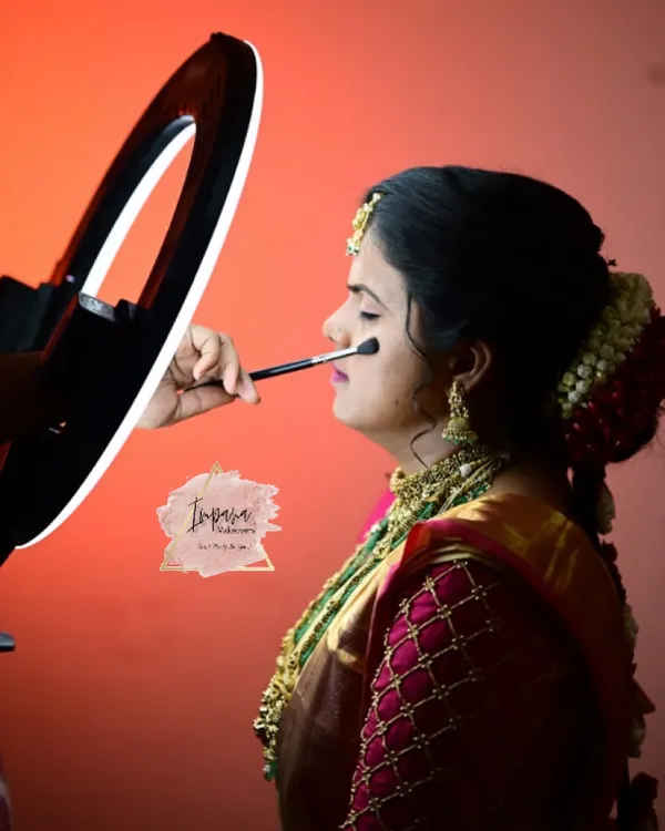 Applying a soft, natural base for a bride's muhurtham look. Using a ring light ensures perfect lighting to see every detail, a tip I share in my online classes for getting your makeup just right.
