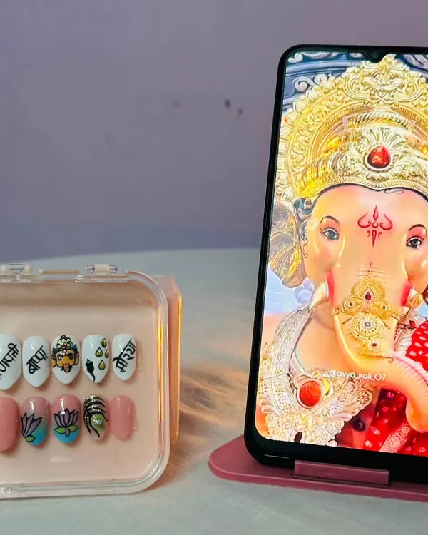 My hand-painted press-on nail set for Ganesh Chaturthi. I poured all my devotion into painting details like the Ganpati portrait, lotus flowers, and the sacred "Shree" symbol.