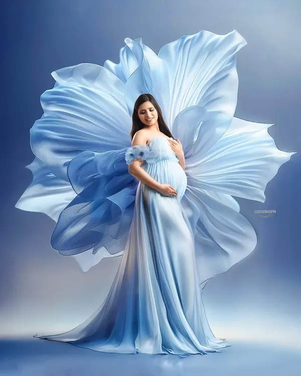 This is one of my signature shots, creating a fine art portrait that makes you feel like a goddess. The flowing blue gown and artistic fabric manipulation create a truly breathtaking image, perfect for celebrating your pregnancy journey.