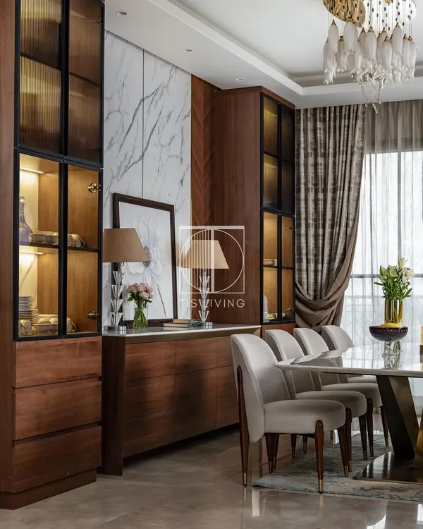This dining room is all about the interplay of materials. We paired our Michelangelo stone-top dining table with a rich wooden credenza and display unit, creating a space that feels both warm and luxurious.