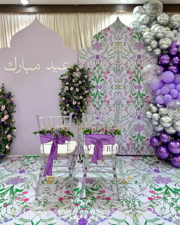 Eid Mubarak! We designed this beautiful photo corner with a lavender color palette, custom Arabic calligraphy, floral-print backdrops, and a modern balloon garland.