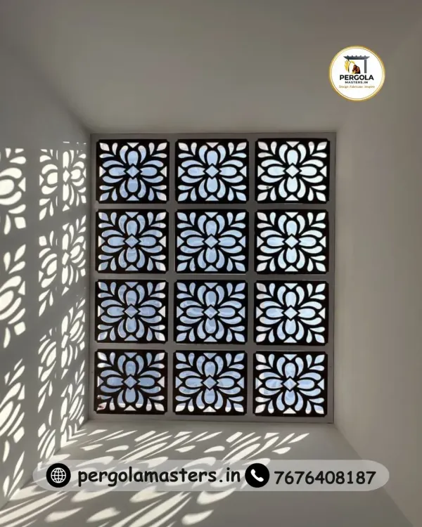 A stunning skylight featuring a floral, laser-cut jali pattern that casts beautiful, artistic shadows on the walls below. This design turns natural light into a dynamic decorative element, brightening the space with elegance.
