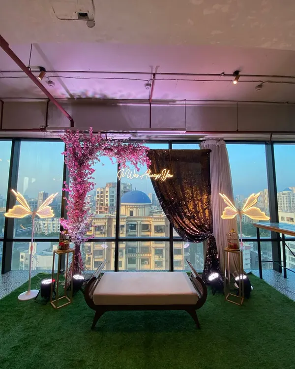 An intimate and romantic setup perfect for a proposal or engagement photo shoot. We created a floral arch with a custom neon sign against a city view, making the moment truly special.