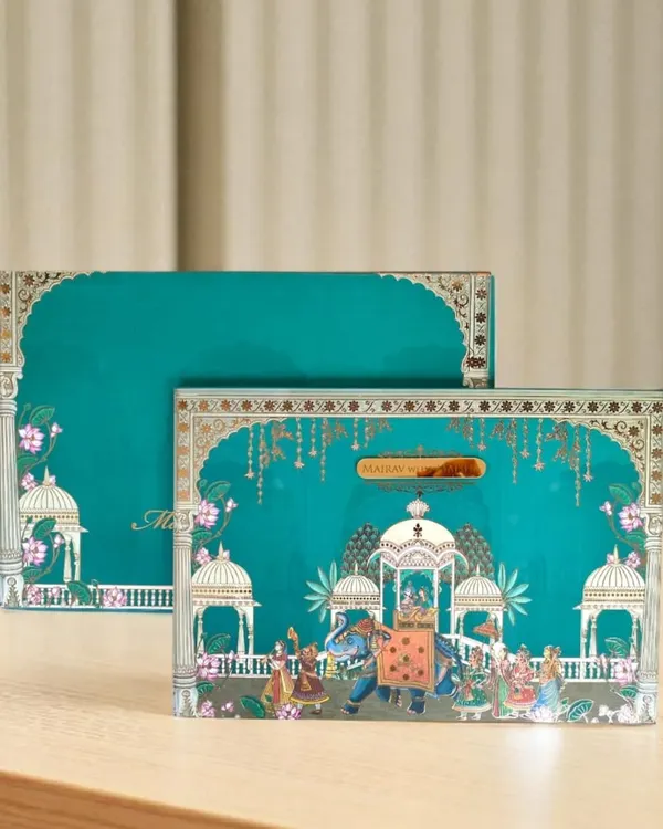 Another example of my Pichwai-themed collection, this invitation box features a royal procession with decorated elephants. The artwork is detailed with gold accents, making it a piece of art in itself.