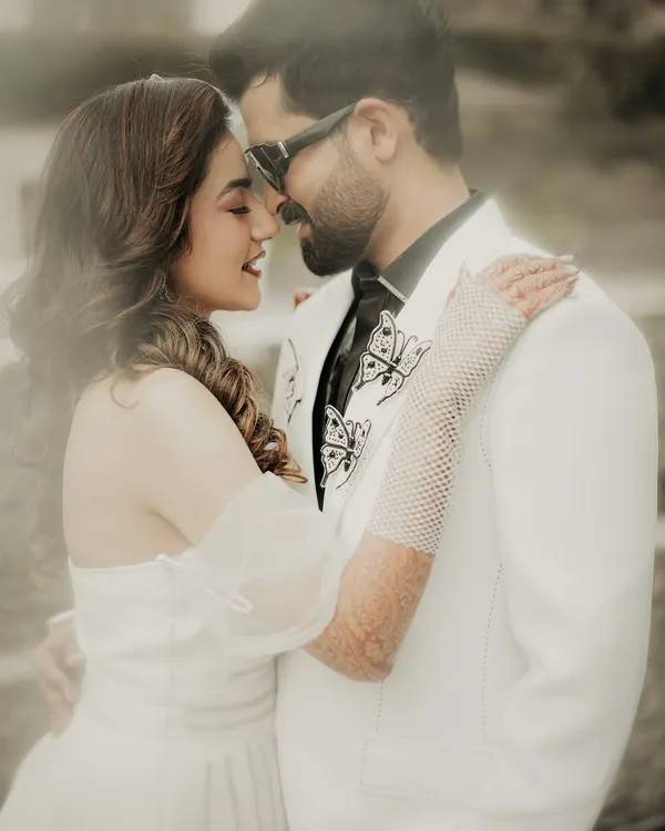 A close-up, dreamy portrait of the couple. The soft focus and their gentle expressions create an intimate and romantic atmosphere, perfectly capturing their love.