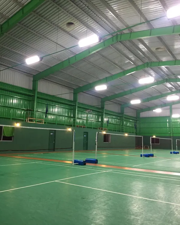 A side view of our multiple indoor courts, highlighting the high ceilings and structural design that allows for high clears and smashes without any overhead obstruction.