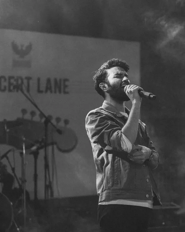 A black and white shot that captures the feeling of being completely absorbed in a song on stage.