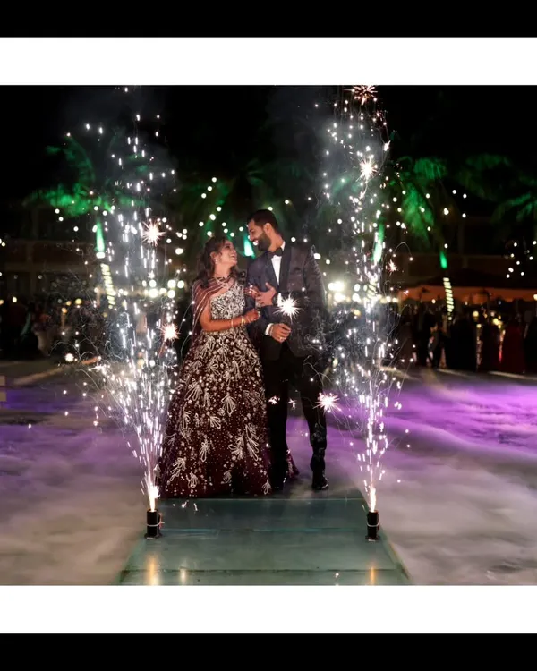 A show-stopping reception entrance with cold pyro fireworks creating a magical, star-lit path for the couple. This is how you make an entrance.