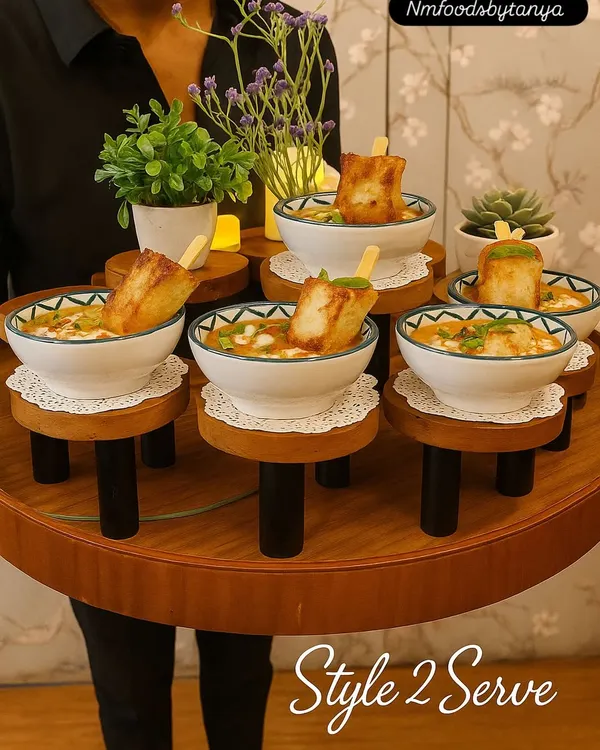 This is what we call 'Style to Serve'. Our staff presents dishes like this Khowsuey with fried tofu on unique, elevated trays, making it easy for guests to enjoy a delicious bite without leaving their conversation.