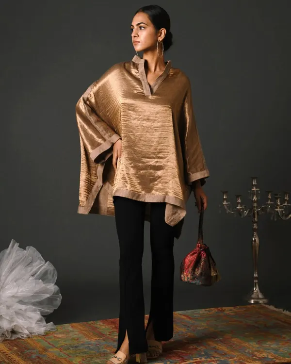 For this festive season campaign, I styled a lustrous gold kaftan top with sleek black trousers. The art direction focused on creating a sense of understated luxury, perfect for elegant evening wear.