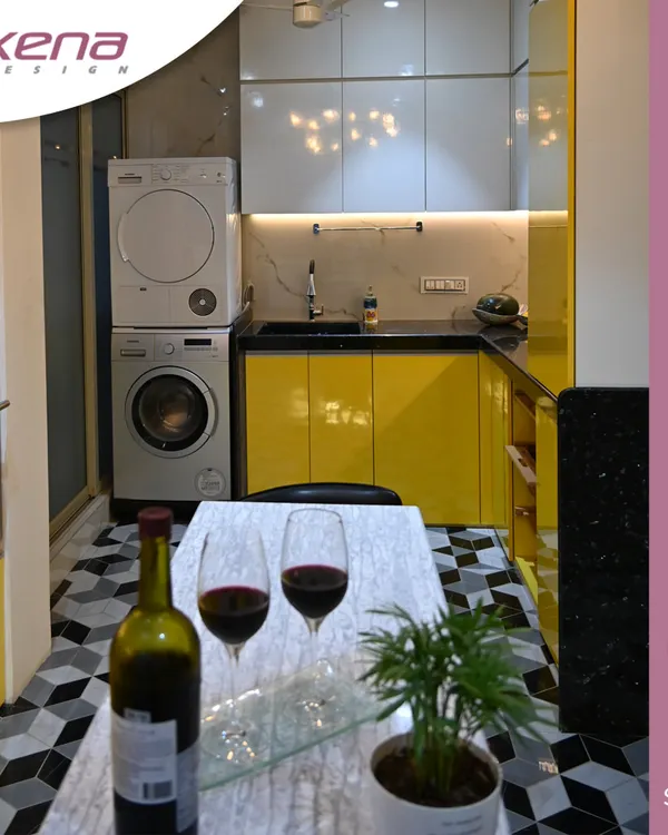 For clients who love a pop of color, this contemporary kitchen is a great example. The bright yellow glossy cabinets are paired with a geometric floor tile and a stacked washer and dryer unit, demonstrating how to create a functional and vibrant utility space within the kitchen.