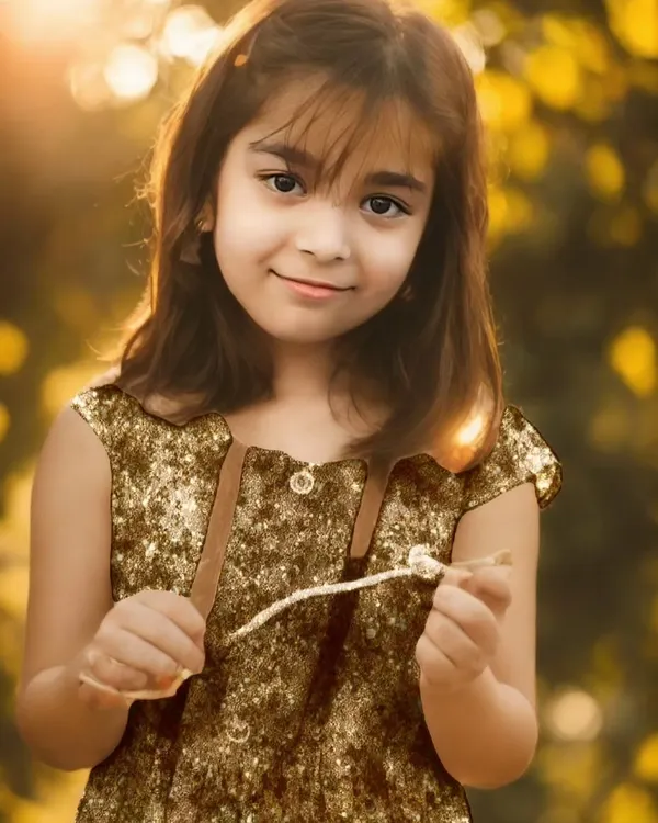 A golden hour portrait of a young girl, capturing her gentle smile and the angel shine in her eyes. I love working with natural light to create these soft, timeless moments for family photoshoots.