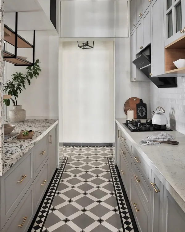 In this Mumbai apartment with Nordic design influences, the cement concrete finish tiles add a modern, rustic touch to the floors. They provide a contemporary backdrop for the shaker-style cabinets in a super matte grey laminate finish.