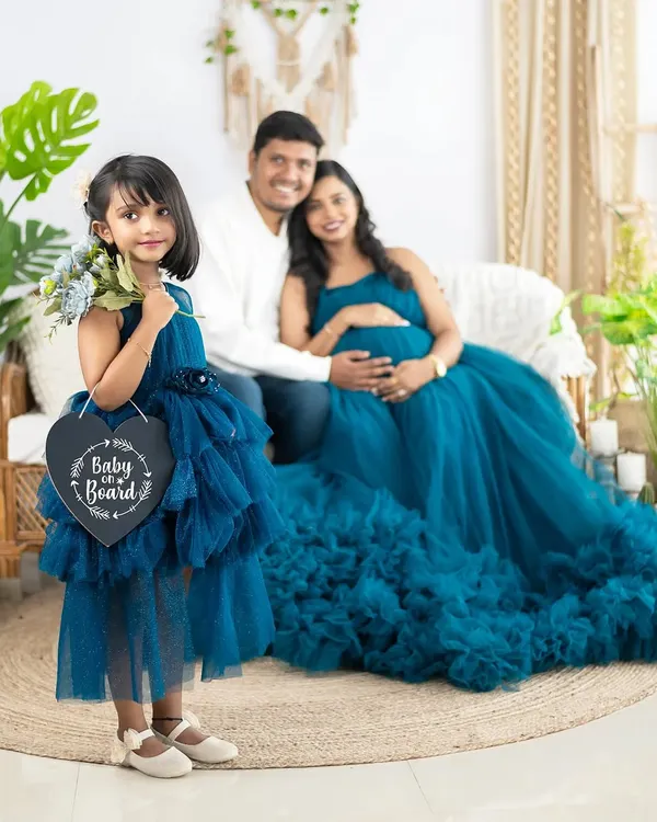 Another adorable way to announce a new arrival. The older sister holds a 'Baby on Board' sign, officially including her in the family's growing story.