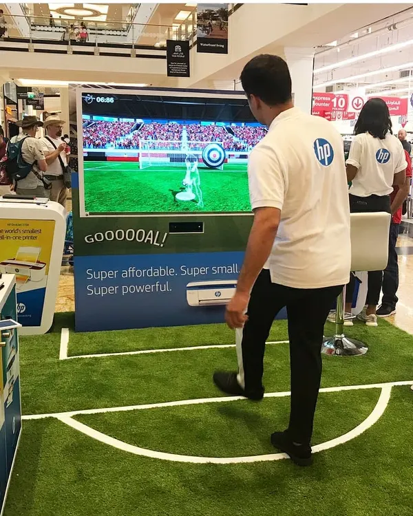 Here is our motion-sensing soccer game in action at an HP brand activation. Participants kick a real ball towards a large screen, where sensors track its speed and trajectory for a fun and competitive penalty shootout experience that draws a crowd.