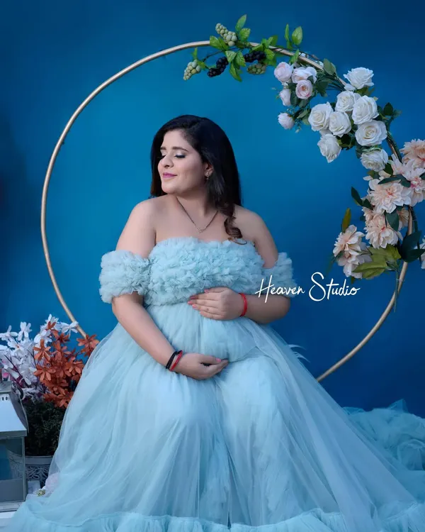 This ethereal, off-the-shoulder tulle gown in a soft powder blue is a client favorite. It creates a dreamy, fairytale look perfect for a magical studio session.