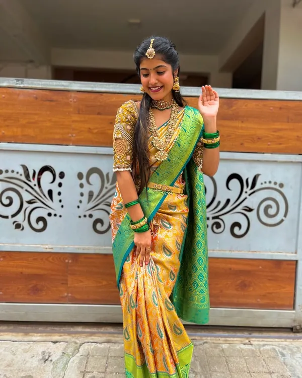 This is the kind of look I love creating for special occasions. This beautiful pure Kanchipuram silk saree in yellow with a contrasting green border and a heavily embroidered custom blouse is perfect for a bride's big day.
