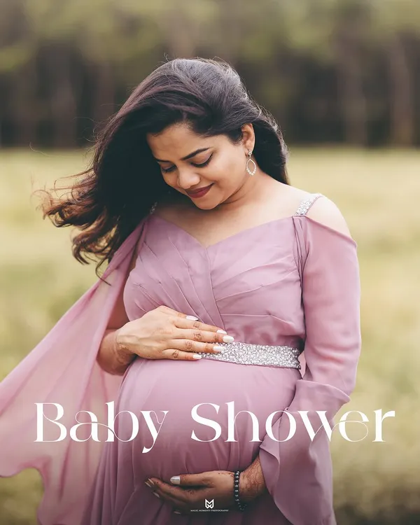 A moment of quiet reflection for the mom-to-be. This portrait in a beautiful mauve gown highlights the peaceful side of pregnancy amidst a soft, natural setting.