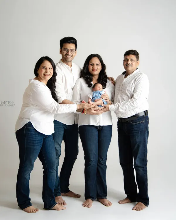 A beautiful multi-generational family portrait celebrating the arrival of a newborn. We gathered the new parents and grandparents for this special shot, coordinating simple white shirts and jeans to create a timeless, unified look.
