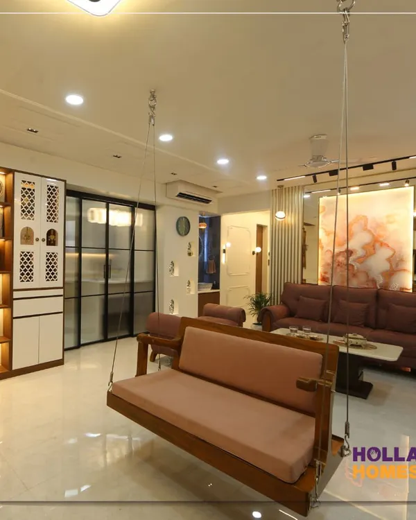This living room captures the soul of a traditional Maharashtrian home with a modern twist. The centerpiece is a classic wooden swing, or 'jhoola', creating a perfect spot for family conversations and quiet moments. It’s a space that feels both grand and grounded.