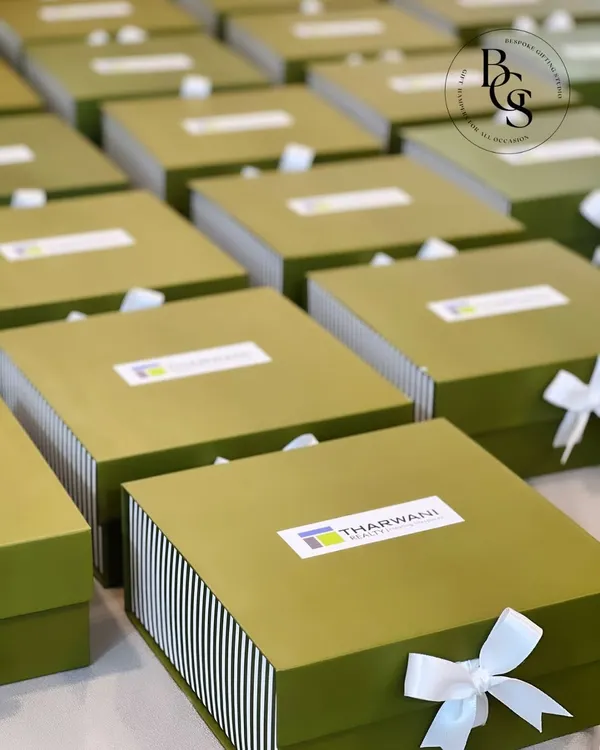 For my corporate clients like Tharwani Realty, I design gift boxes that are both professional and personal. These custom-branded olive green and striped boxes were created for a large-scale event, reflecting the brand's identity with a clean, sophisticated aesthetic.