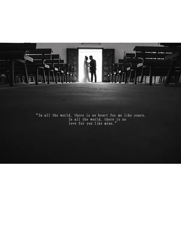 A dramatic black and white silhouette of a couple standing at the church doorway, a powerful and cinematic start to their life together.