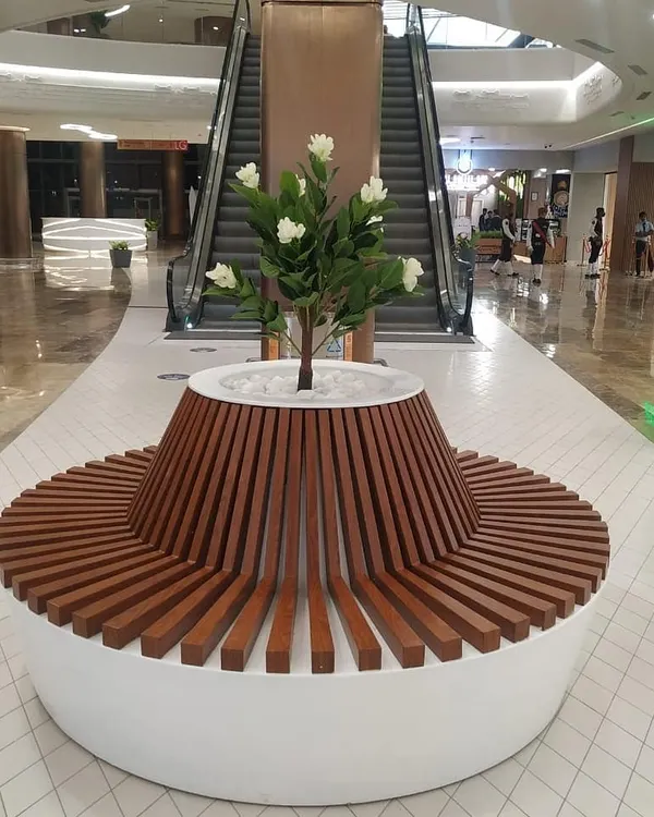 I love creating functional art, like this custom circular bench with an integrated planter at Lulu Hypermarket. It provides seating for shoppers while seamlessly incorporating a beautiful artificial flowering tree, making it a natural centerpiece for the corridor.