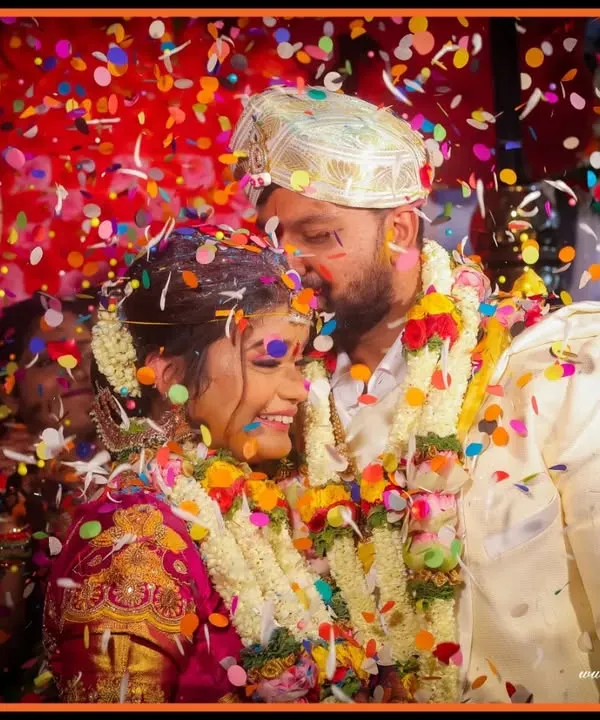 We believe the best wedding photos are filled with life and energy. This moment, with confetti raining down on the happy couple, perfectly captures the peak of celebration and pure, unscripted joy.