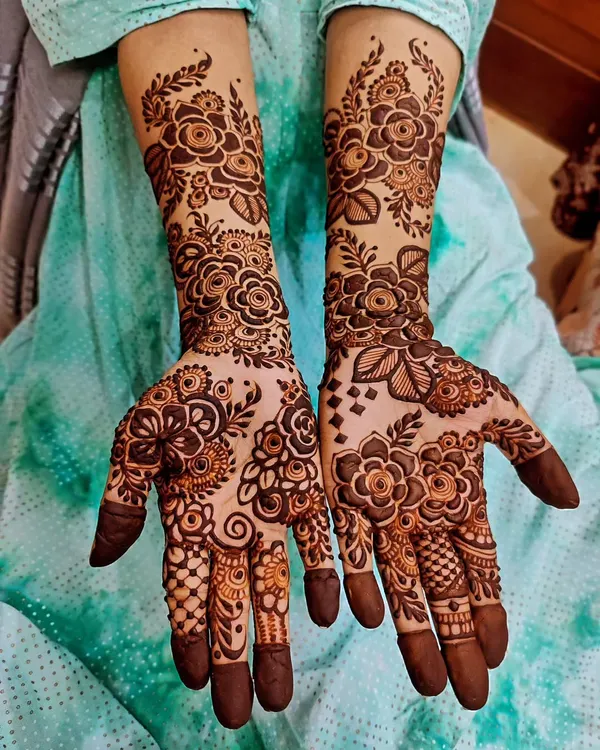 A beautiful example of full-hand mehendi, perfect for a bride or guest of honor. This intricate design features classic floral patterns, delicate paisleys, and detailed finger work, all coming together for a truly stunning look.