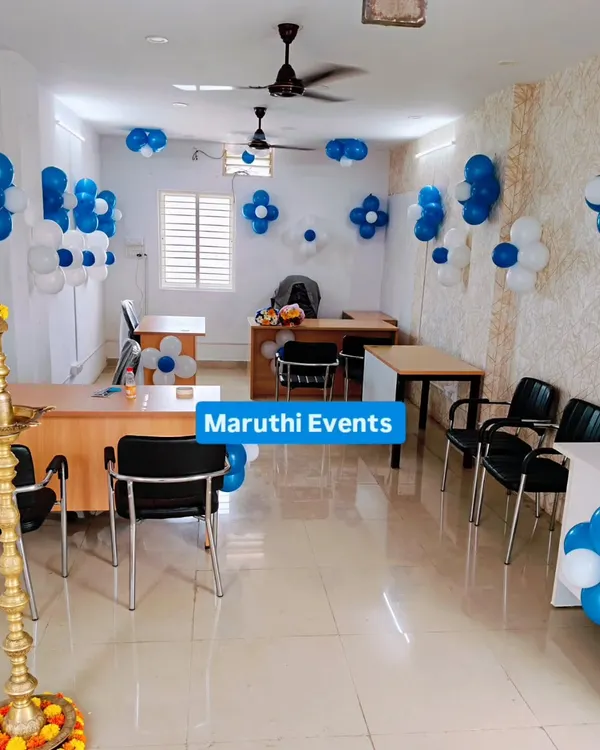 A professional and clean decoration for an office inauguration. This setup uses blue and white balloon clusters to add a festive touch without being overwhelming.