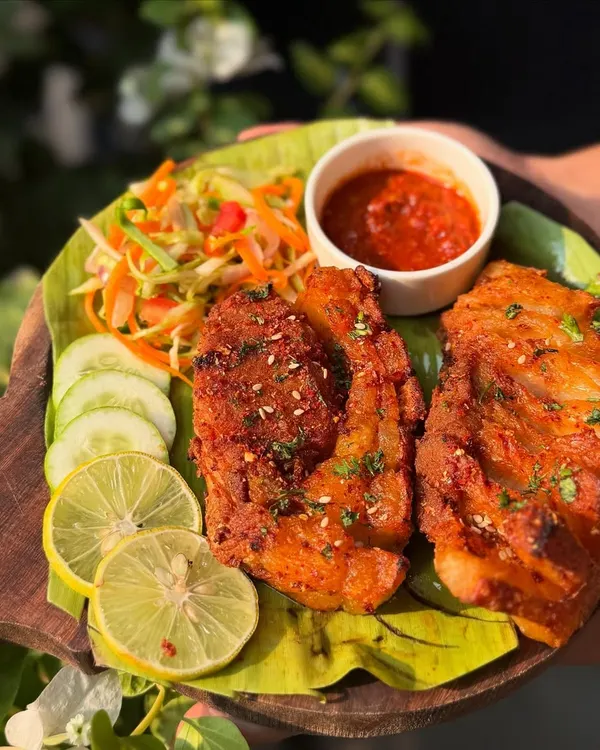 Our Crispy Pork Belly is back by popular demand. Each piece is fried to a perfect golden crisp, served on a banana leaf with a side of fresh salad and our spicy house dip.