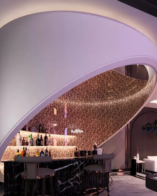 This ceiling-hung bar is a centerpiece of modern luxury. I designed it as a sculptural element, using a sliced cylindrical form and a mirrored ceiling to create a dramatic focal point for entertaining.