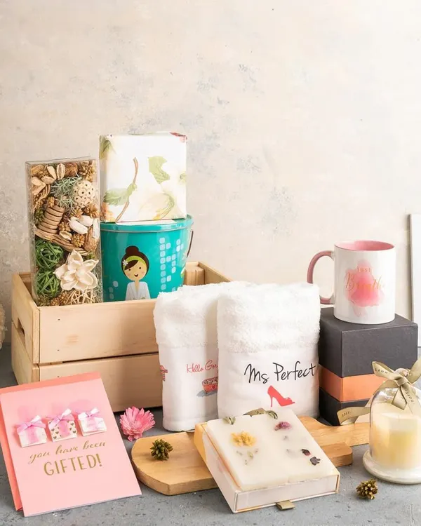 This "Ms. Perfect" pamper hamper is a wonderful gift for the bride. It includes personalized towels, a scented candle, artisanal soap, and other spa essentials packed in a rustic wooden crate.