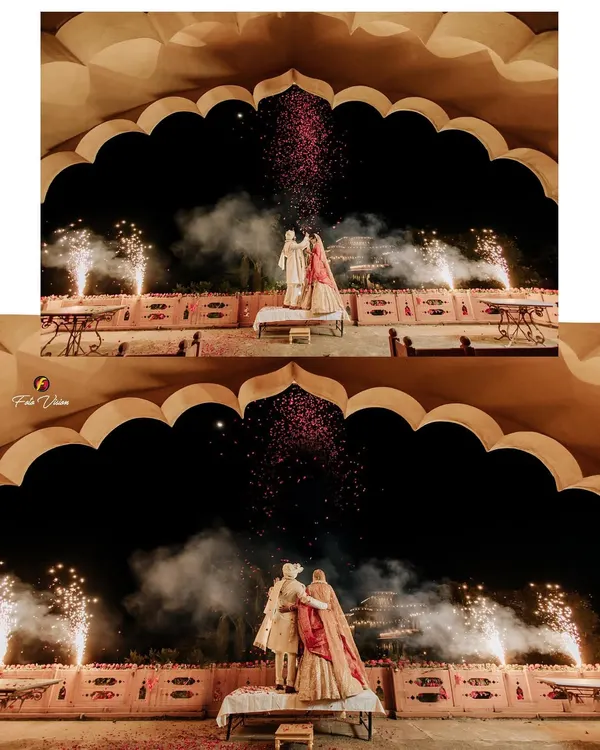Dheemant and Geet's varmala ceremony framed by a stunning palace arch and illuminated by fireworks. We use architectural elements and dramatic lighting to create a sense of royal grandeur for your key wedding moments.