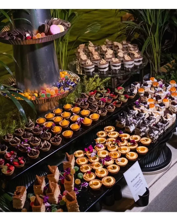 A dessert lover's dream. This lavish dessert spread features a multi-tiered display of chocolate tarts, fruit tartlets, mini cheesecakes, mousses, and traditional Indian sweets.