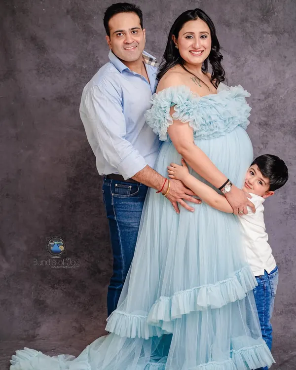 Including older siblings in a maternity shoot makes for the most heartwarming family portraits. This image perfectly captures the excitement of a growing family, with everyone sharing a hug around the baby bump.