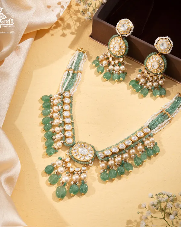 The Tourmaline Trail is a gentle river of gemstones. This set features pastel green tourmaline beads, lustrous pearls, and polki diamonds, flowing into a masterpiece of quiet sophistication and understated luxury.